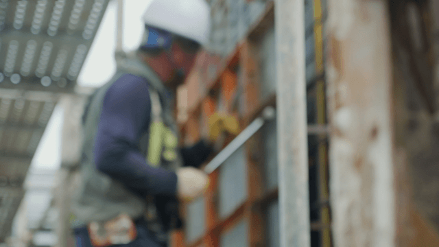 Construction worker using tools on site