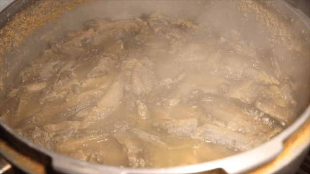 Loach soup boiling on the stove with rising steam