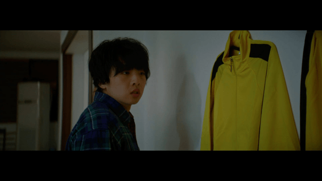 Person looking at a yellow jacket indoors