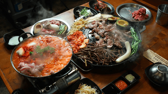 Korean barbecue and kimchi stew on a table