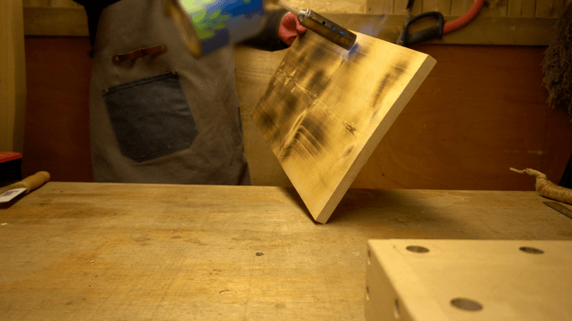 Woodcraft artisan engraving wooden board with hand torch