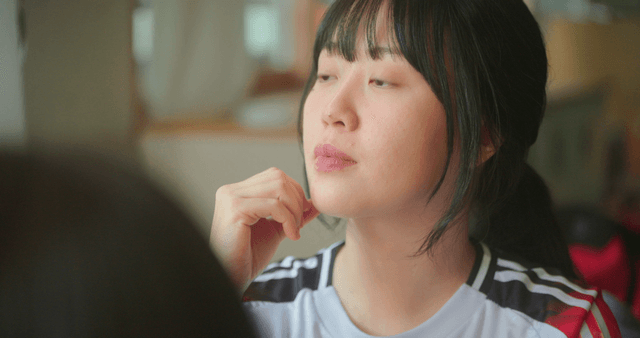 Schoolgirl in gym clothes feeling slightly hurt in a classroom