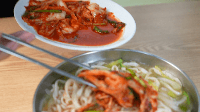 Hand-cut noodles topped with kimchi