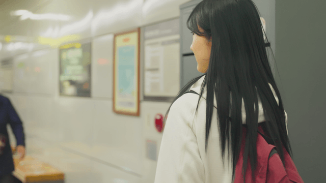 Young woman with backpack getting off subway