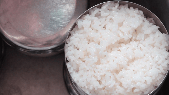 Glossy white rice in a stainless bowl