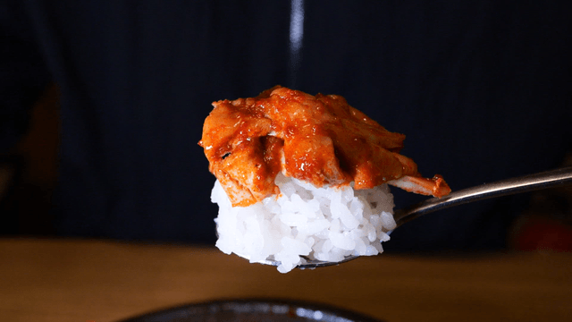 Spicy chicken on rice with chopsticks