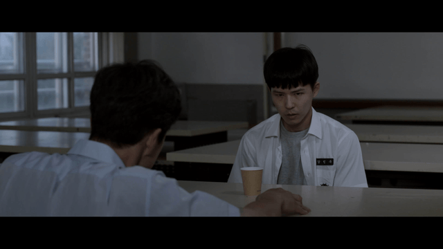 Student and teacher talking seriously while drinking beverage