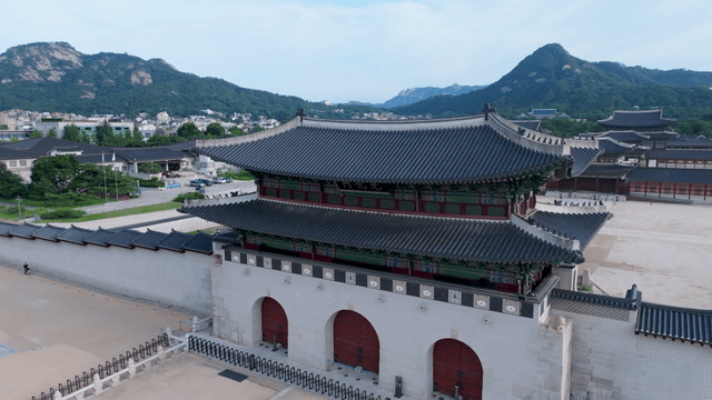Traditional Korean palace with mountain backdrop