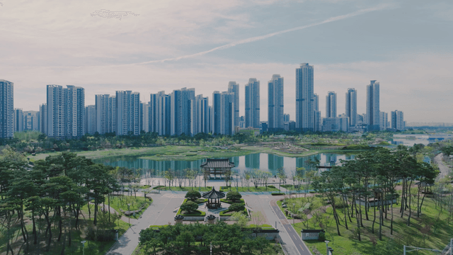 Modern city skyline with park and lake