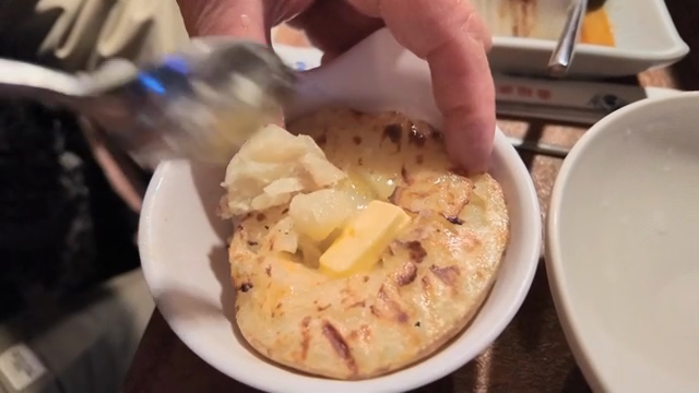 Grilled potato with butter in a bowl