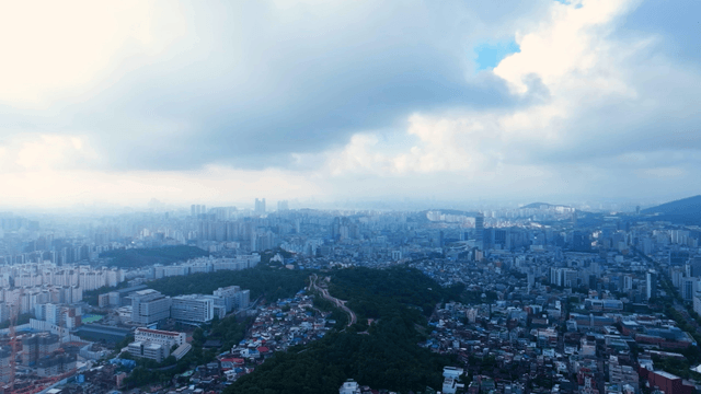 Sprawling cityscape under cloudy skies