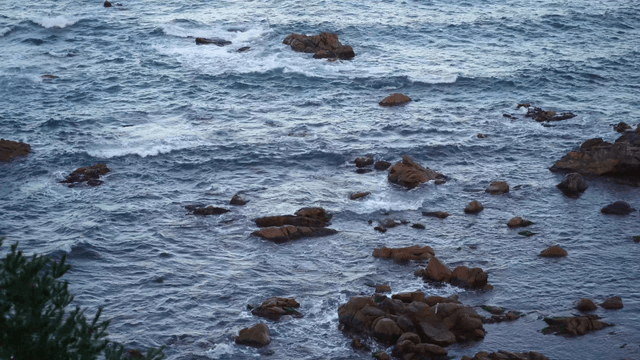Strong waves crashing against coastal rocks