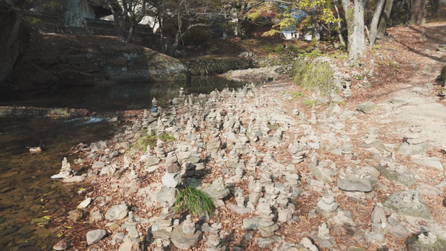 Quiet stream filled with stacked stone towers