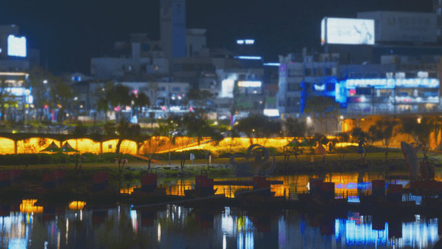 Night view of a lit riverside cityscape