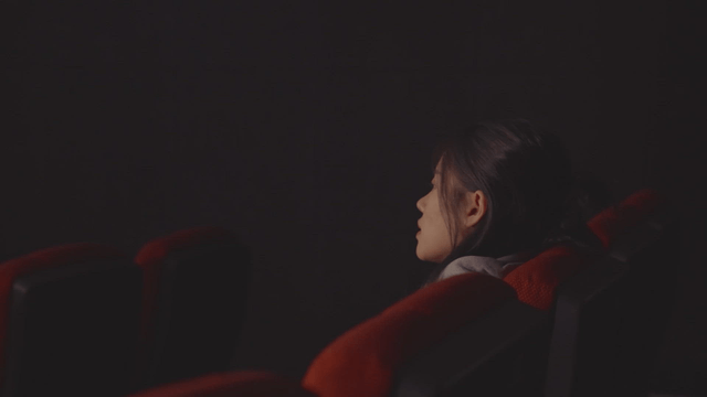 Woman relaxing in a movie theater seat