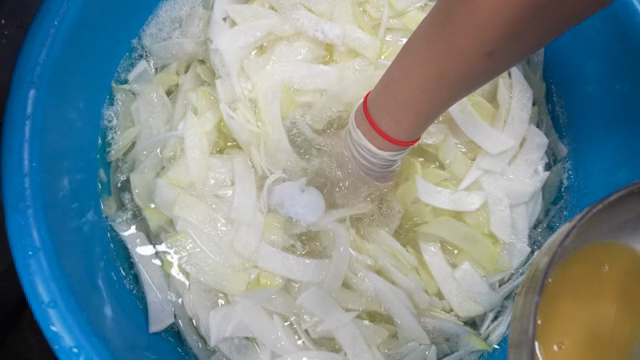 Preparing vegetables in a blue basin
