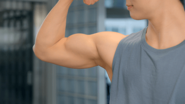 Man flexing muscles indoor