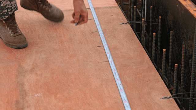 Worker measuring on a construction site