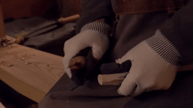 Craftsman carving wood with precision