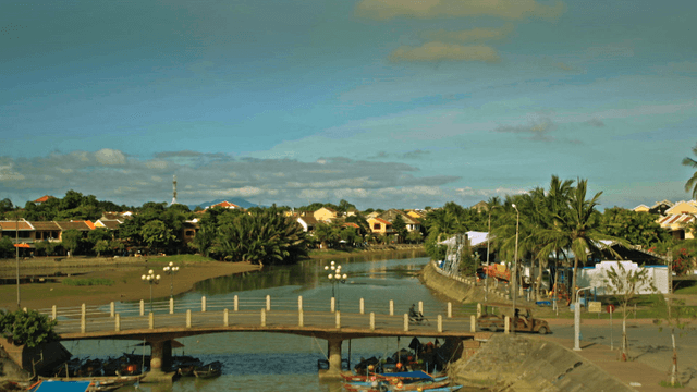A scenic village with a bridge and boats