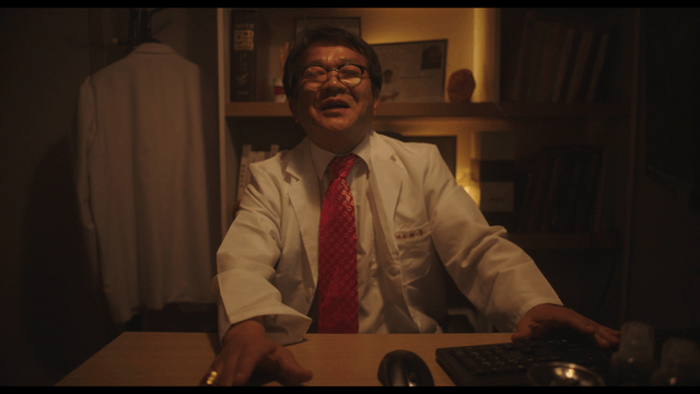 Doctor laughing while pushing away patient’s hand in clinic