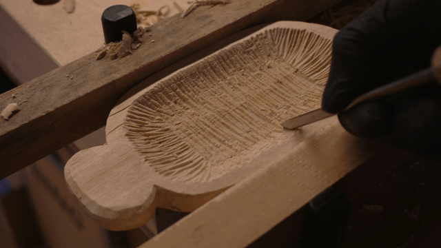 Wood carving in progress on a workbench
