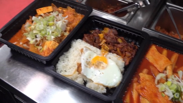 Various Korean dishes in black trays