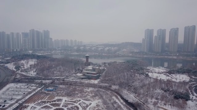 Snow-covered cityscape with tall buildings