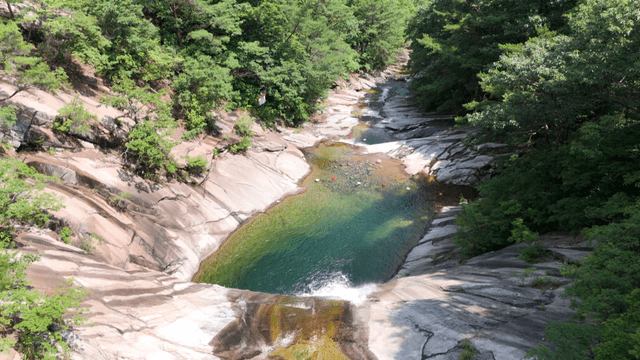 Clear stream stretching along rocky valley
