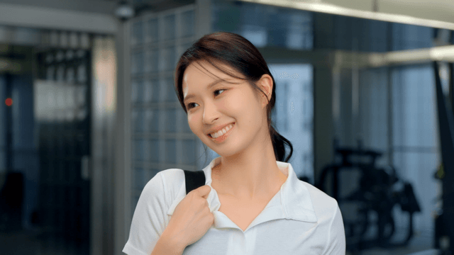 Side view of smiling woman with gym bag