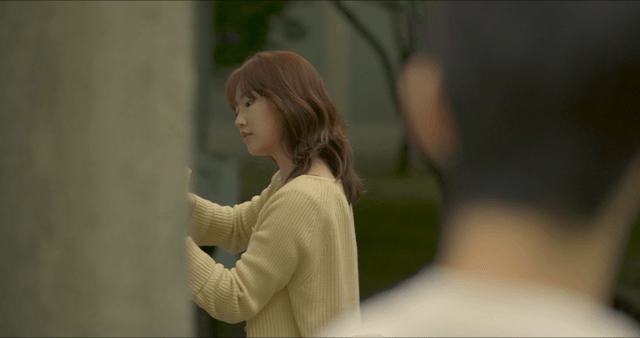 Woman taping on wall outdoors
