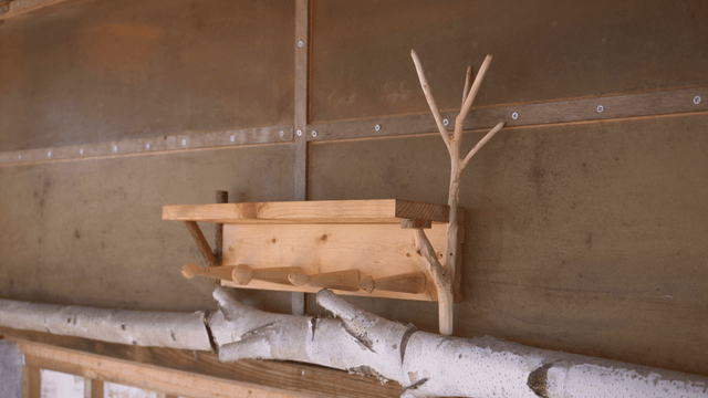 Wooden shelf with white branch design