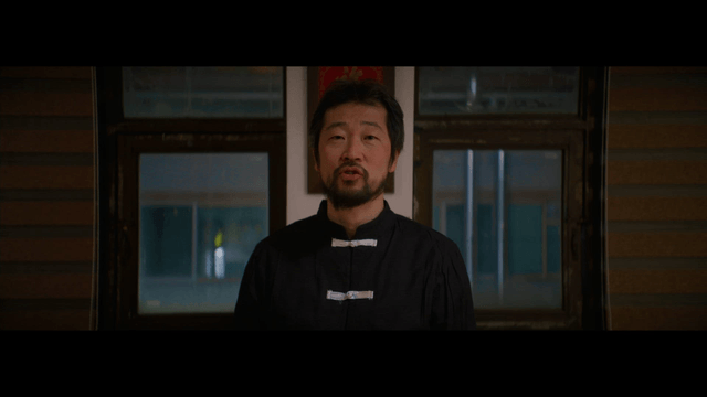Man explaining martial arts indoors
