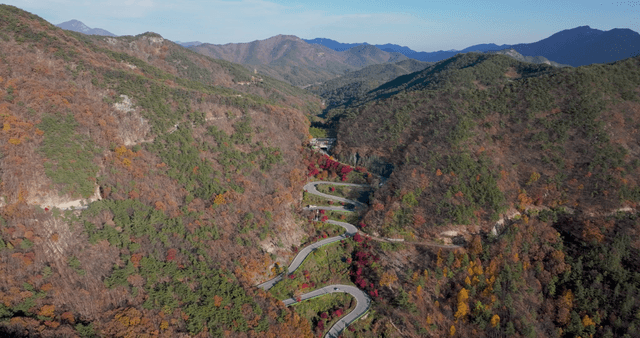 Winding mountain road with autumn foliage
