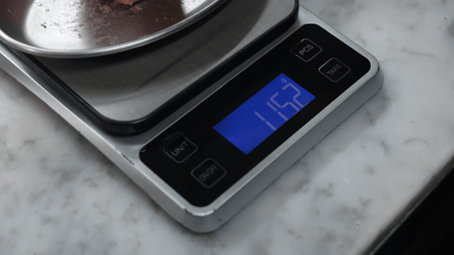 Meatball being weighed on a kitchen scale