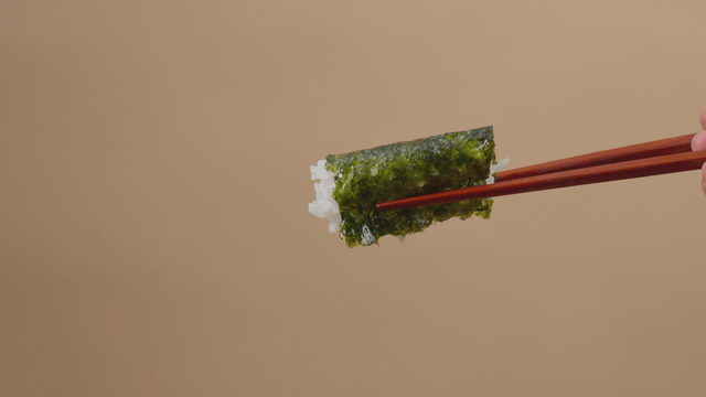 One bite of rice wrapped in seaweed