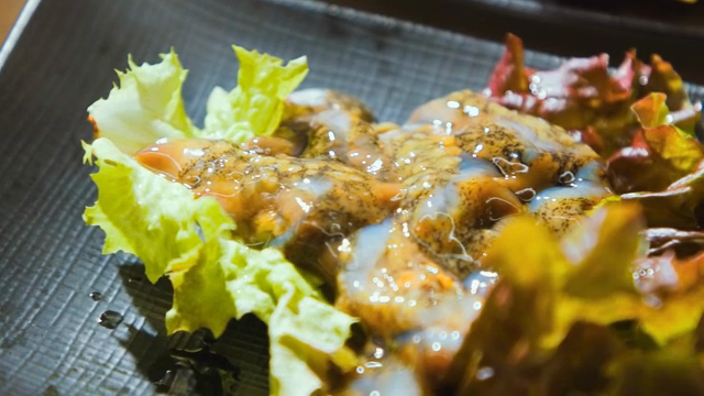 Fresh sea cucumber served on a bed of lettuce