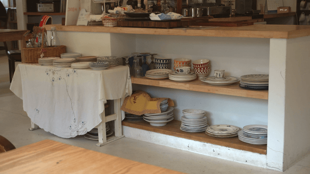 Neatly arranged dishes on a kitchen shelf