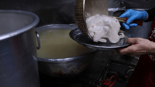 Boiled chicken scooped with a skimmer
