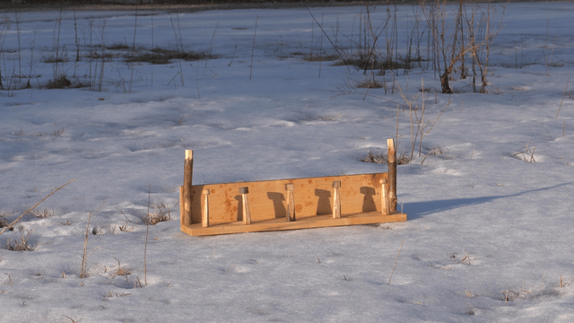 Wooden frame on a snow-covered field