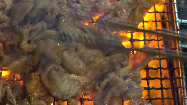 Grilled meat sizzling over open flames