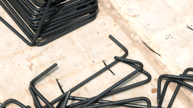 Steel rebar scattered on a concrete floor