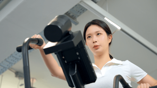 Woman exercising on a machine at gym