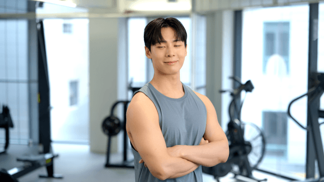 Young man standing confidently in a gym