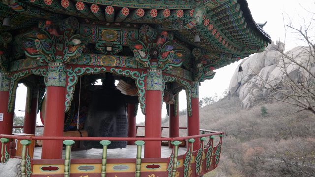 Traditional Korean pavilion with a large bell
