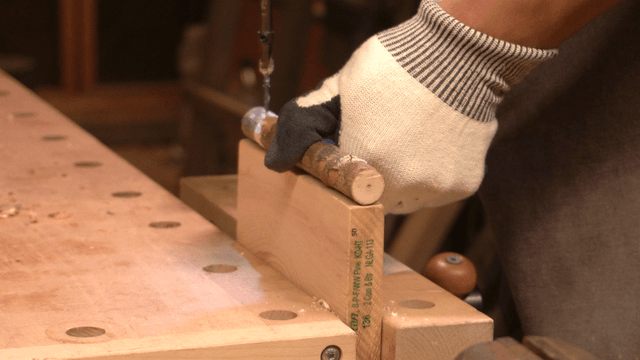Woodcraft artisan working with drill and wooden piece