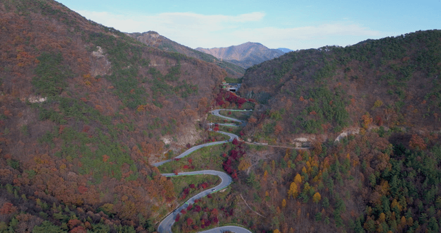Winding mountain road with autumn foliage