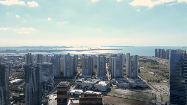 Modern cityscape with high-rise buildings overlooking the sea