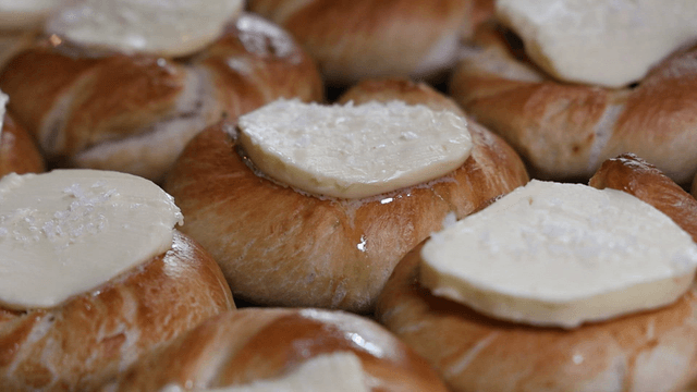 Freshly baked bagel topped with butter