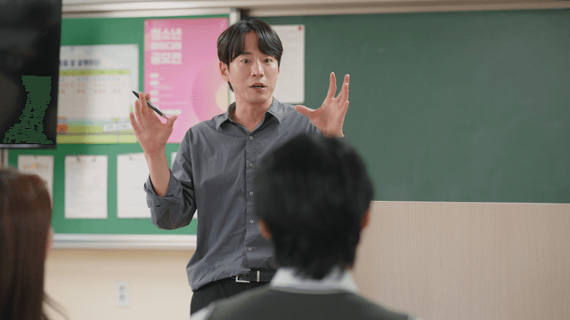 Teacher gesturing while communicating with students during class